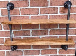 repurposed pallet and iron pipe wall hanging shelf