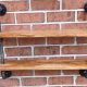 repurposed pallet and iron pipe wall hanging shelf